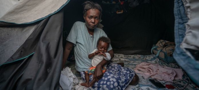 imageHaiti © UNOCHA/Giles Clarke A woman and her child, who was born in the tent in which they sit. There are 600 families now living at a former school in downtown Port-au-Prince.